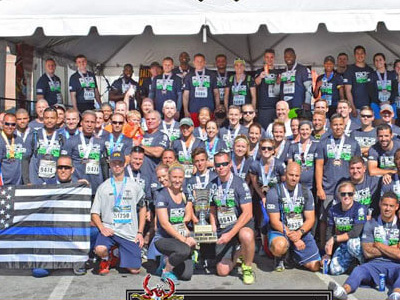 group of police officers pose for baltimore running festival